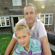 Joe, pictured with dad Lee, is now feeling much better, but his fellow pupils have been told to stay at home