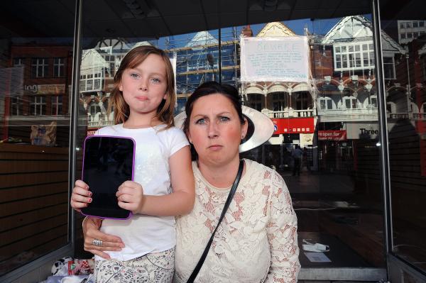Angry – Dawn Murphy with daughter Lois. Right: The now-empty shop where Mrs Murphy took the tablet for repair.